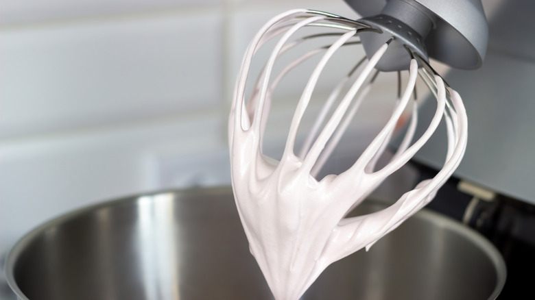 Closeup of whipped egg white meringue on mixing bowl attachment