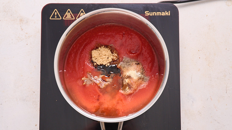 barbecue sauce ingredients in a saucepan over induction cooktop