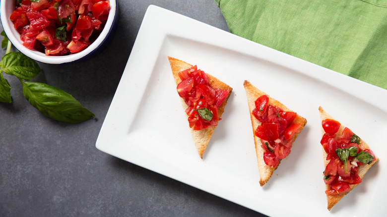 bruschetta served on white dish