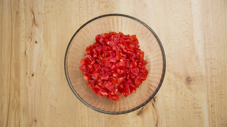 chopped tomatoes in glass bowl