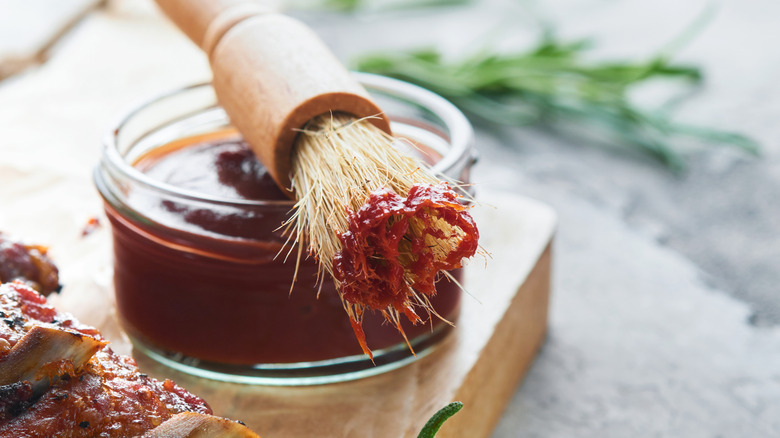 Bowl of barbecue sauce with brush