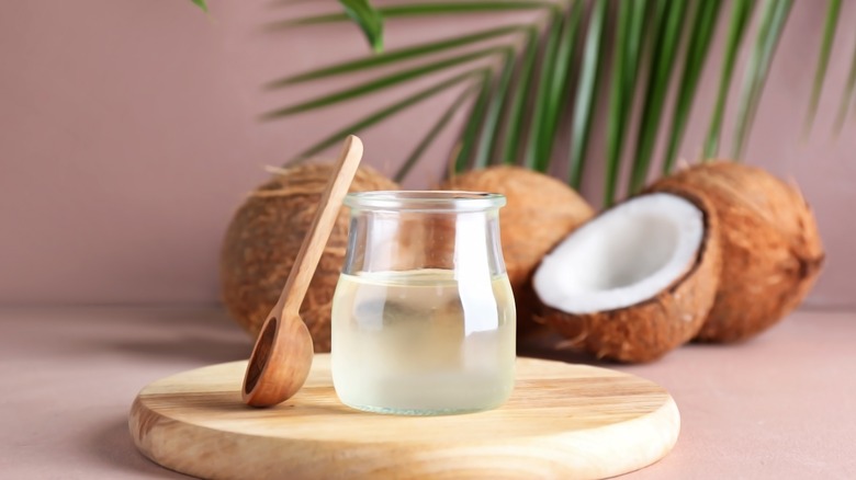 coconut oil in a jar next to fresh coconut