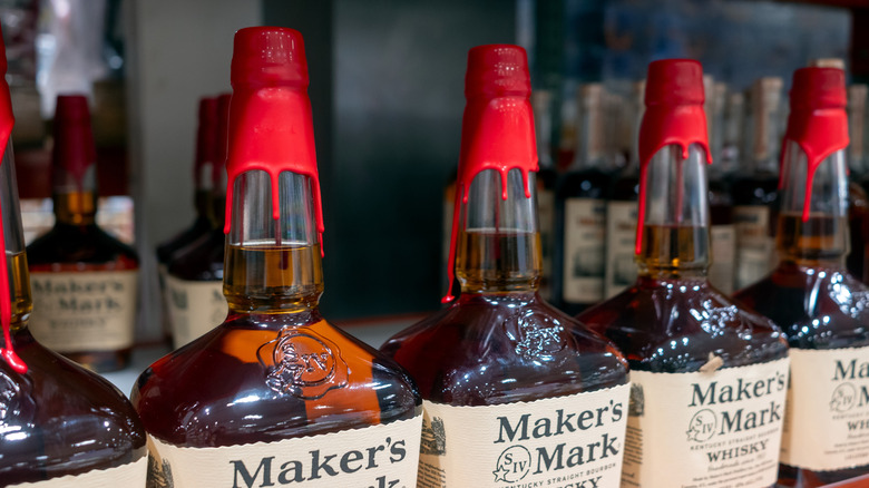 Several bottles of Maker's Mark bourbon whiskey with its distinctive red wax seal