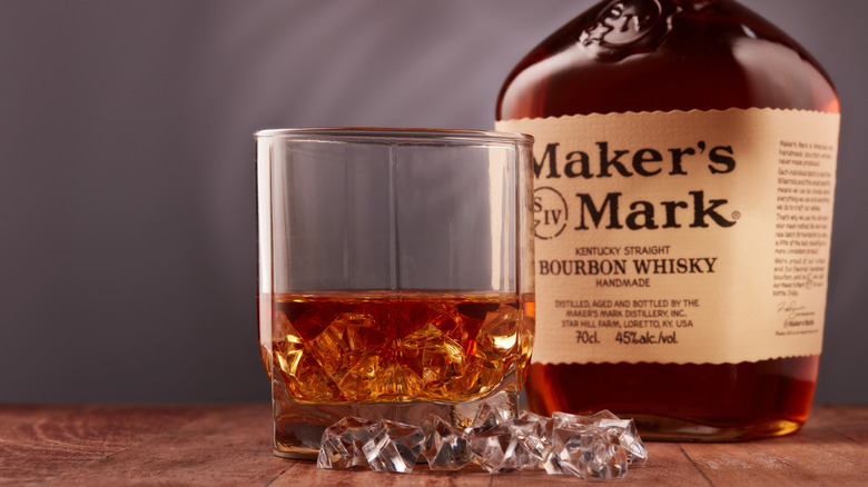 Glass of Maker's Mark next to a bottle