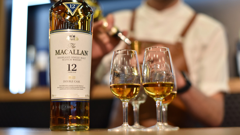 The Macallan single malt Scotch whisky bottle and multiple glasses.