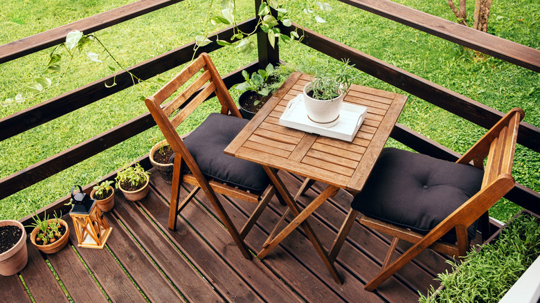A wooden furniture set on a balcony