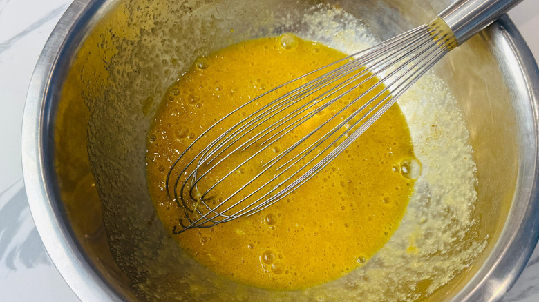 Egg mixture and whisk in bowl