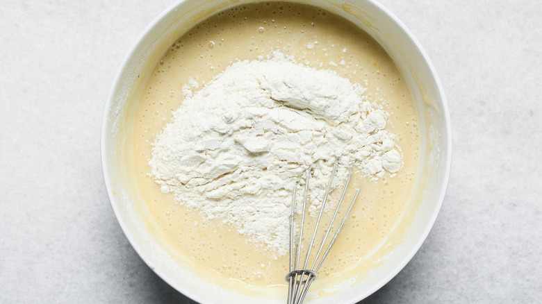 Vanilla cake mix batter with a whisk