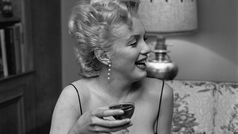 Marilyn Monroe laughing having a drink