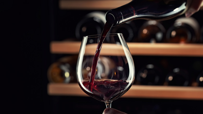 Red wine being poured into a glass