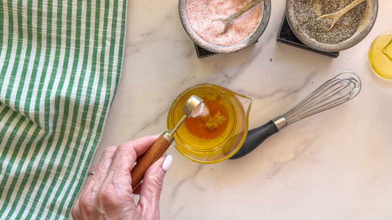 hand pouring salt into bowl