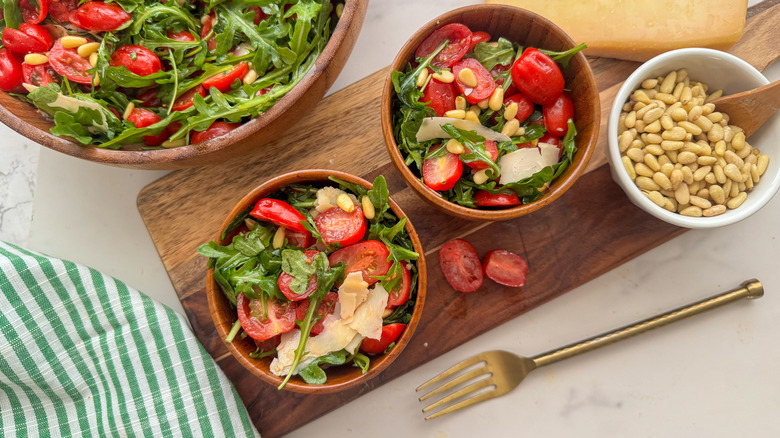 2 bowls of marinated tomato and arugula salad