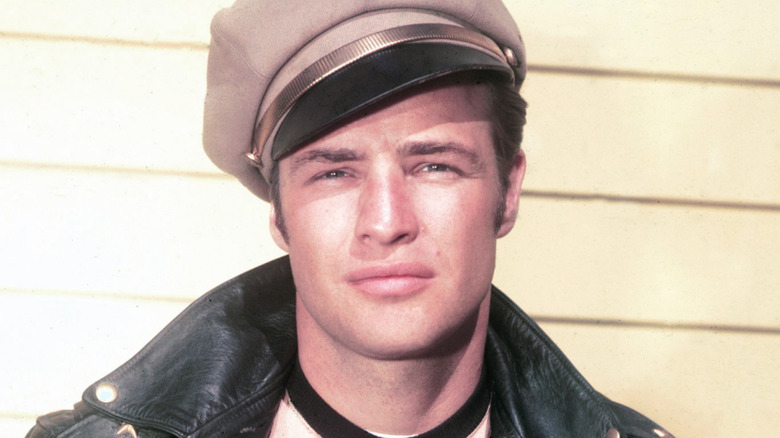 young Marlon Brando in a hat and leather jacket
