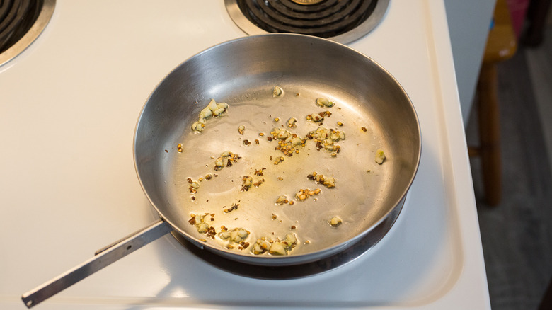 garlic and red pepper flakes frying in pan
