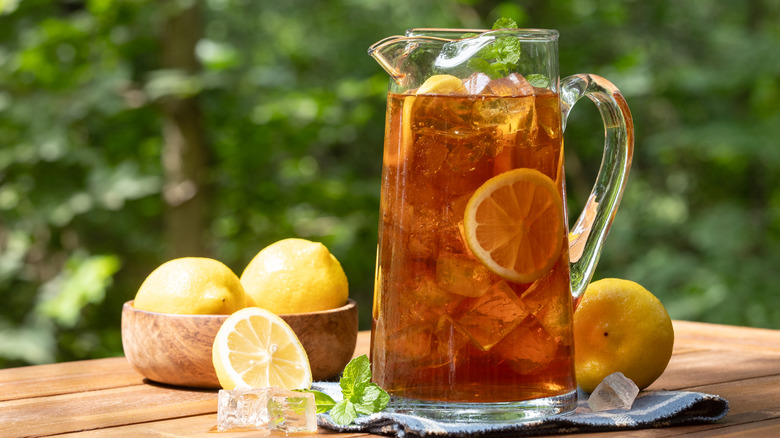 pitcher of iced tea outside, lemons mint