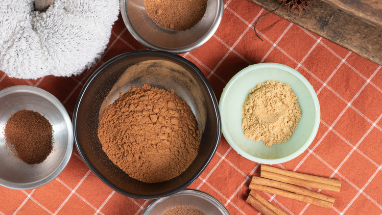 Bowls of brown spices on a linen cloth