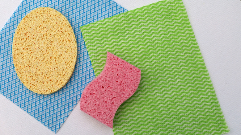An array of colorful kitchen sponges and towels on a kitchen counter