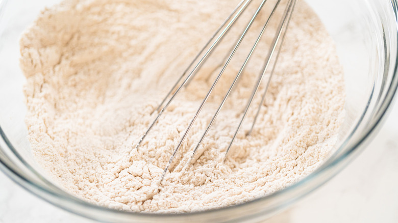 Whisking flour mixture in glass mixing bowl