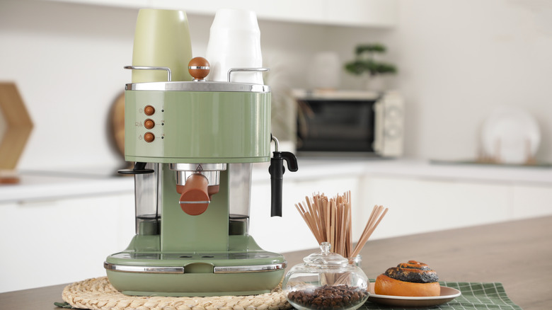 Coffee area in a kitchen featuring a green espresso machine