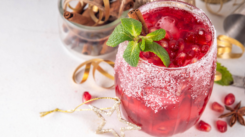 Red mocktail with holiday decoration, pomegranate seeds