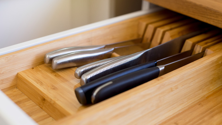 Knives lying in a bamboo drawer organizer