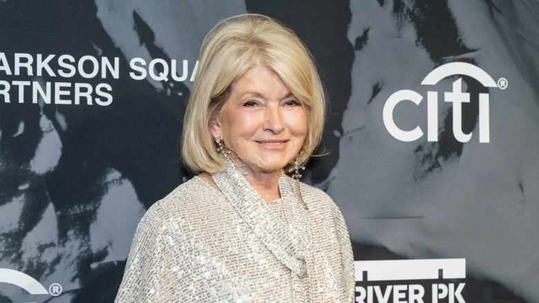 Martha Stewart standing next to gray sign