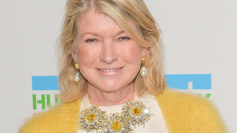 Martha Stewart smiling with yellow sweater and statement necklace