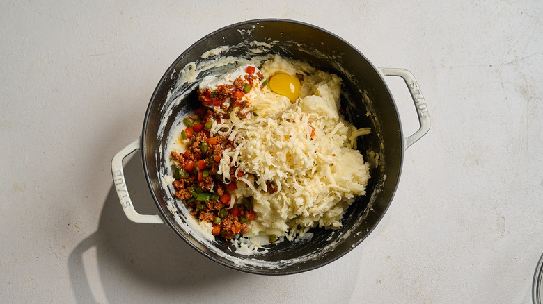 combining potatoes with chorizo in a pot
