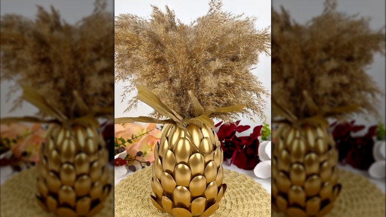 Gold spoon-covered jar with plants