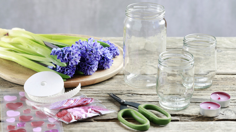 Mason jars with flowers and crafting supplies
