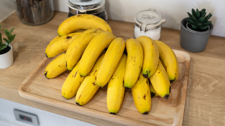 A bunch of bananas sitting on a kitchen counter