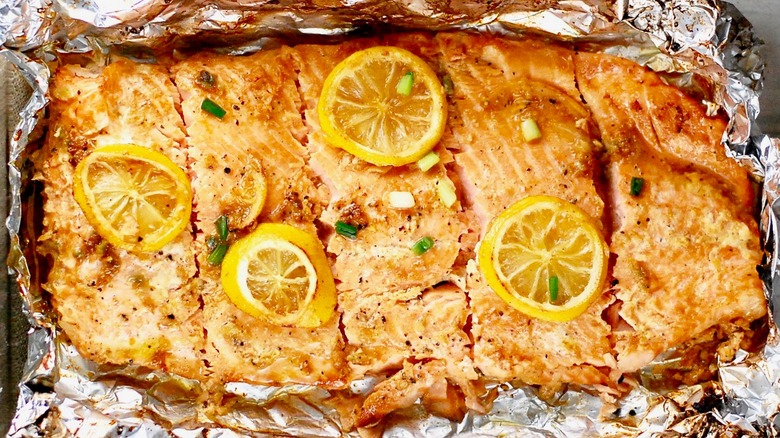 Baked salmon with lemon slices on tinfoil