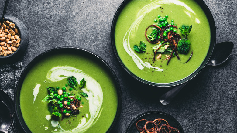 Green soup with cream swirl