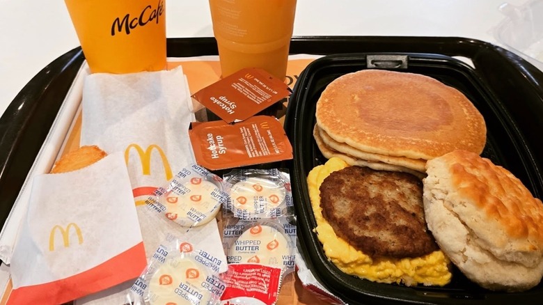 McDonald's Big Breakfast with butter and syrup packets, coffee, and juice
