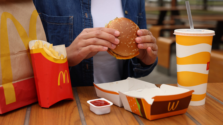 person preparing to eat a McDonald's sandwich