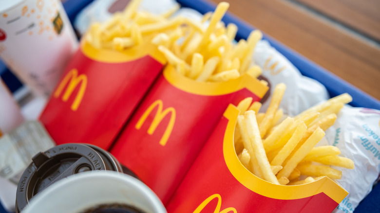 Three packs of McDonald's fries on a serving tray