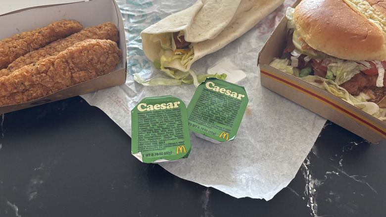 McDonald's Caesar sauce packets surrounded by chicken menu items