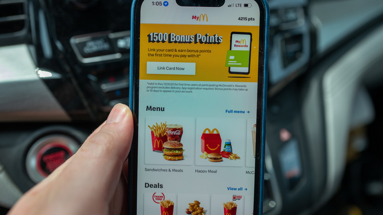 hand holding phone while scrolling McDonald's app