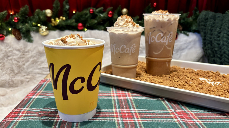 McDonald's Cookie Butter Latte on table with Cookie Butter Iced Coffee and Frappé behind
