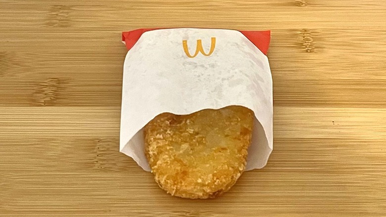 A McDonald's hash brown on a wooden cutting board