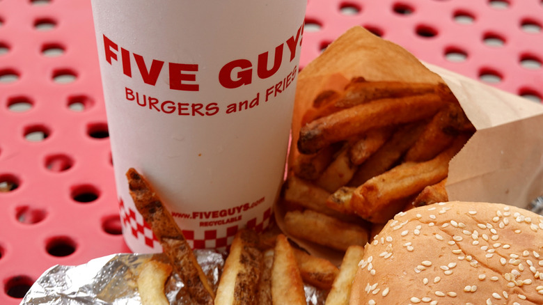 A combo consisting of a hamburger, drink, and french fries from Five Guys