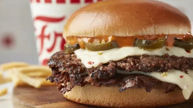 A jalapeno pepper jack burger from Freddy's featuring crispy-looking patties, melted cheese, and visible jalapenos on a bun
