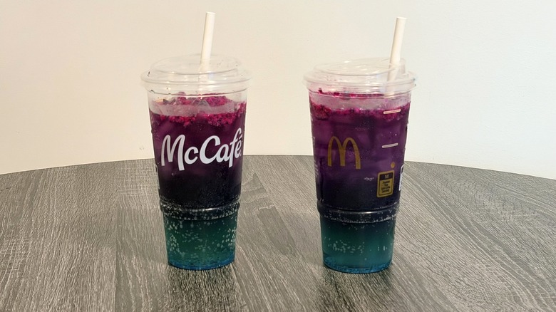 Regular and zero-sugar McDonald's Red Bull Dragonberry Energizer on table