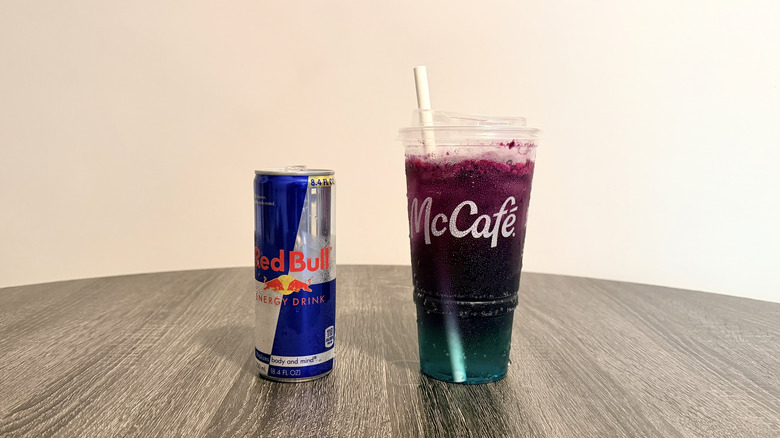 A can of Red Bull alongside a zero-sugar McDonald's Red Bull Dragonberry Energizer
