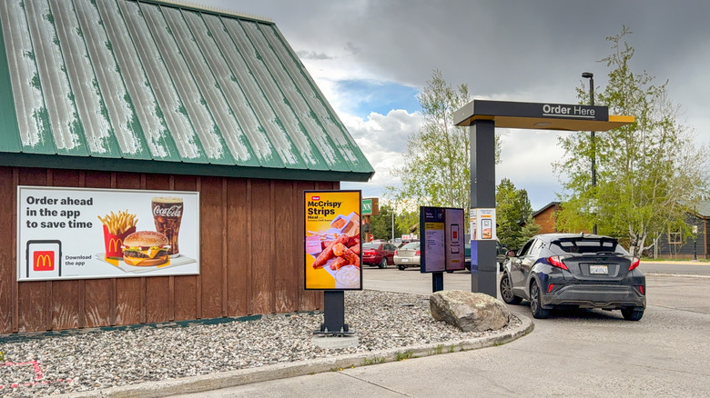 Car stopped at the ordering point in a drive thru McDonald's restaurant