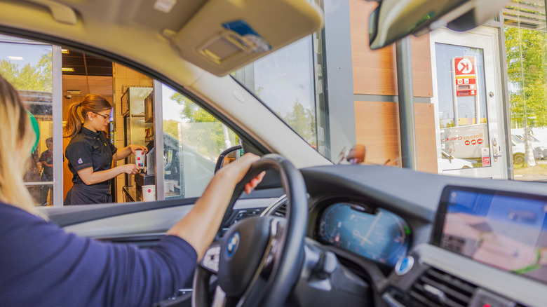 Driver looking at server through drive-thru window at McDonald's