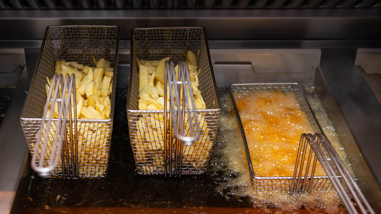 French fry baskets in a deep fryer