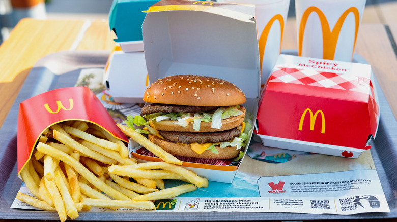 McDonald's meal spread with fries, a burger, Spicy McChicken, and soft drink