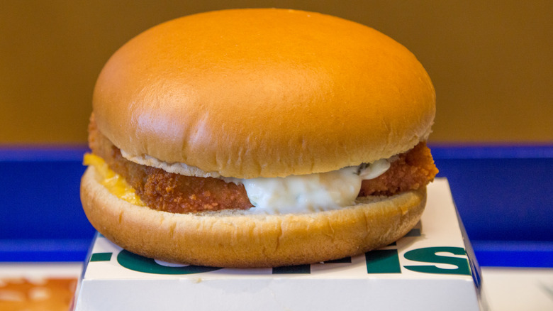 A Filet-O-Fish sandwich sitting on top of its container
