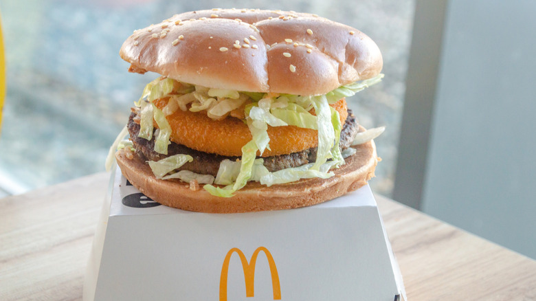 A McDonald's burger patty along with a chicken patty on a bun